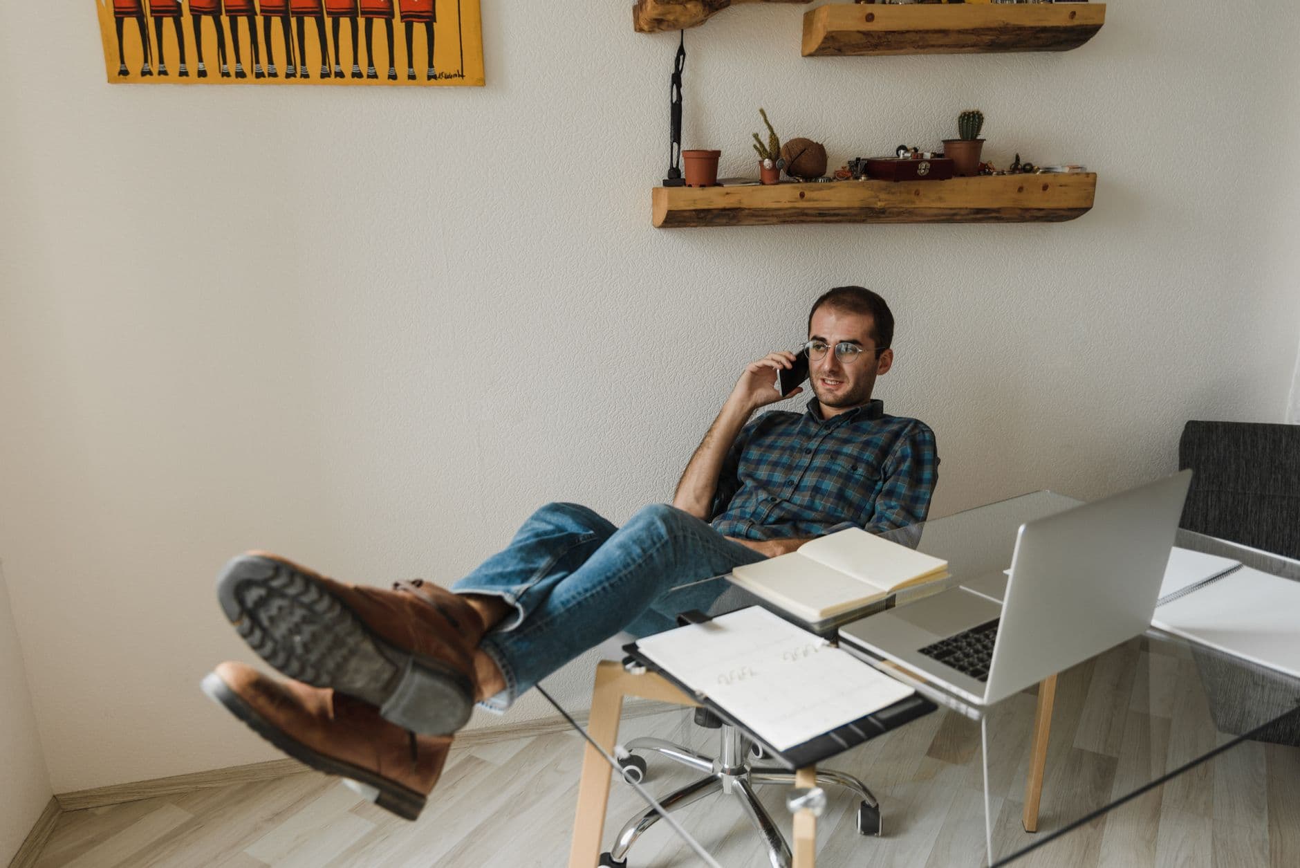 Someone on a phone call at a desk with a notebook open