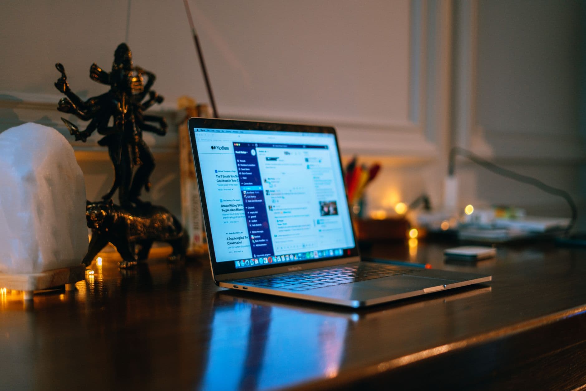 A laptop showing a task dashboard on a desk