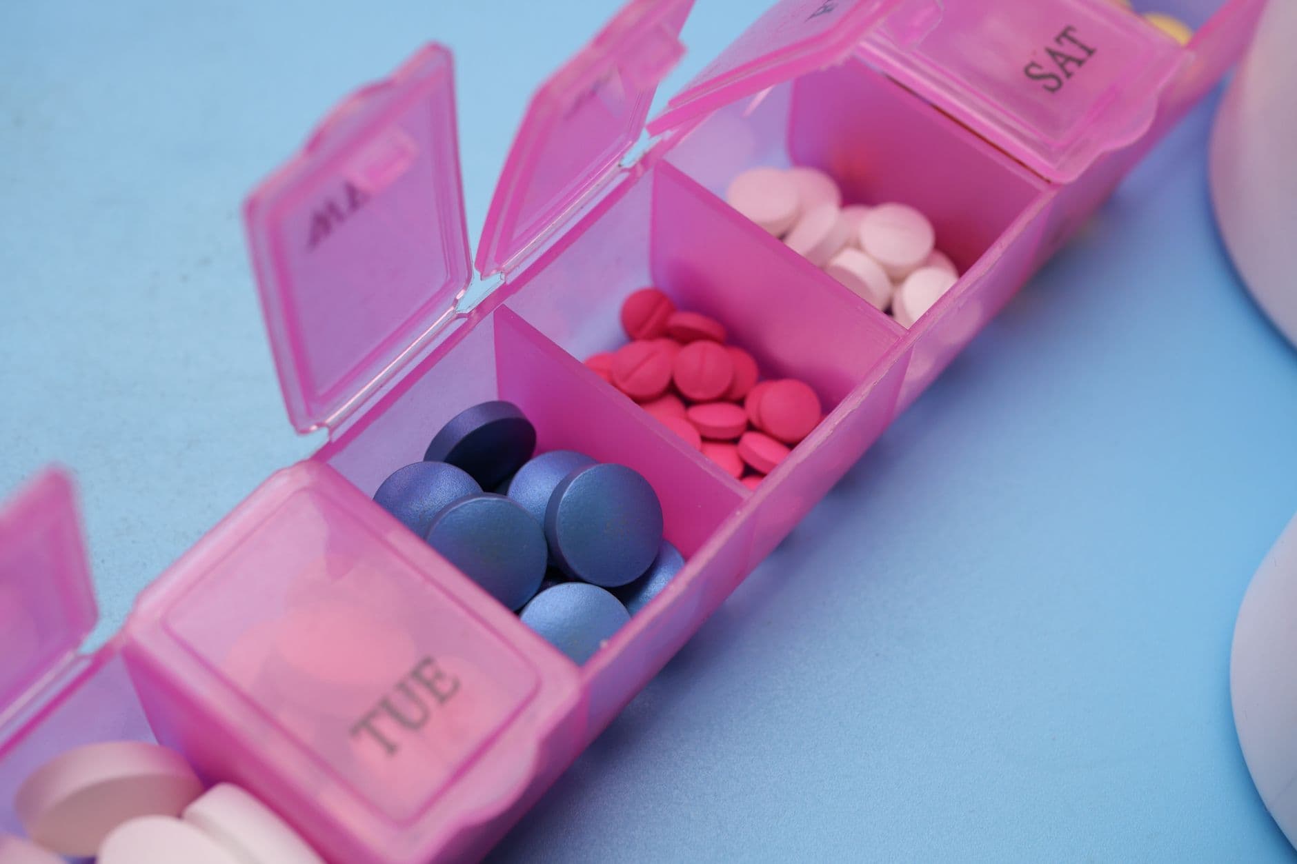 A weekly pill organiser on a kitchen counter