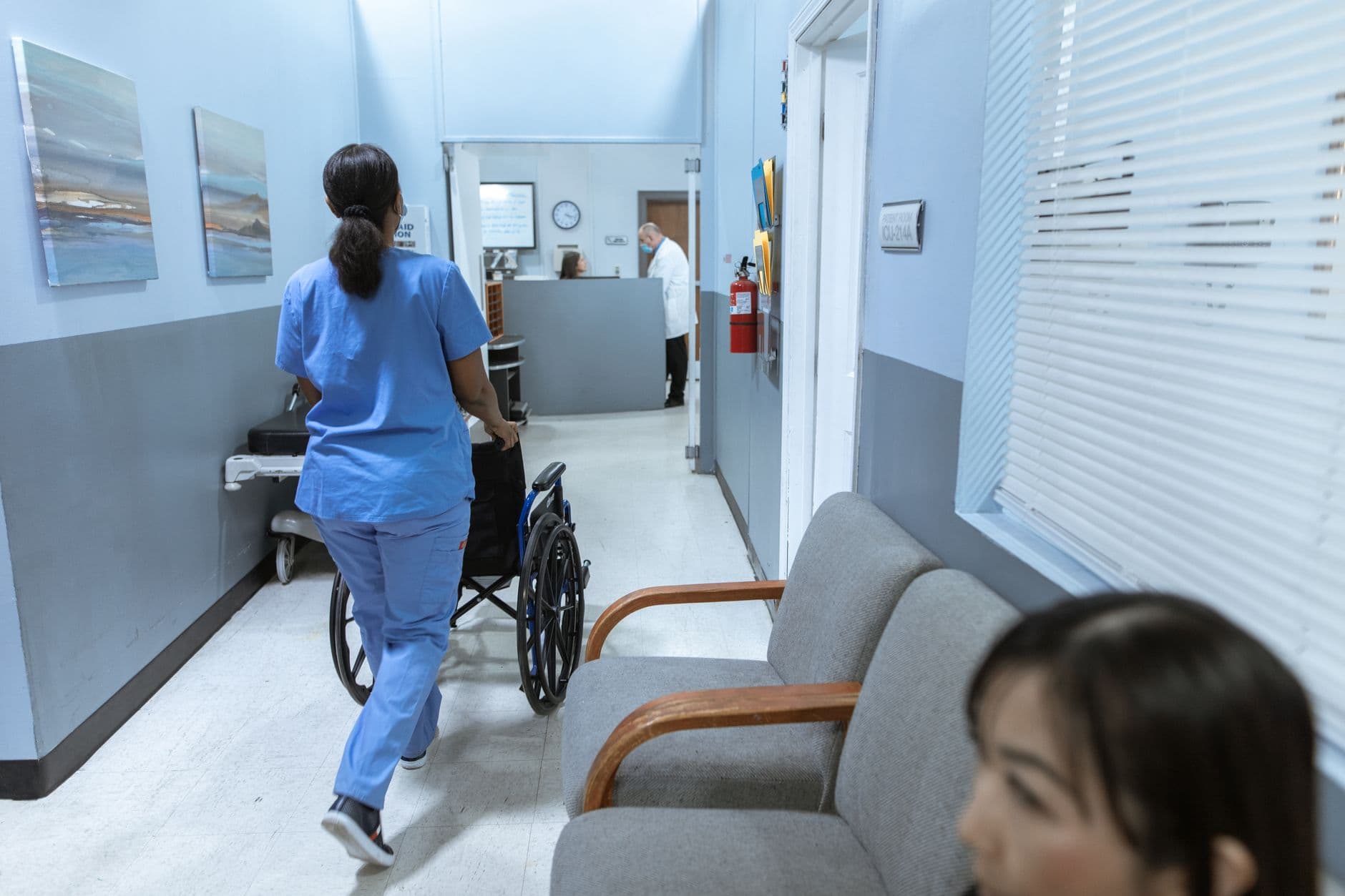 A doctor checking his smartphone in a hospital corridor