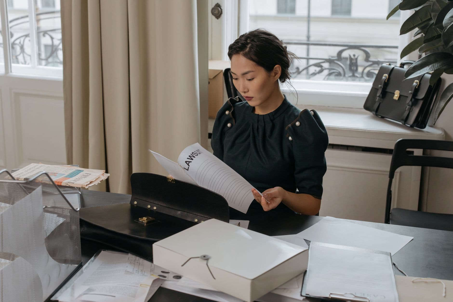 A lawyer reviewing legal documents at a desk