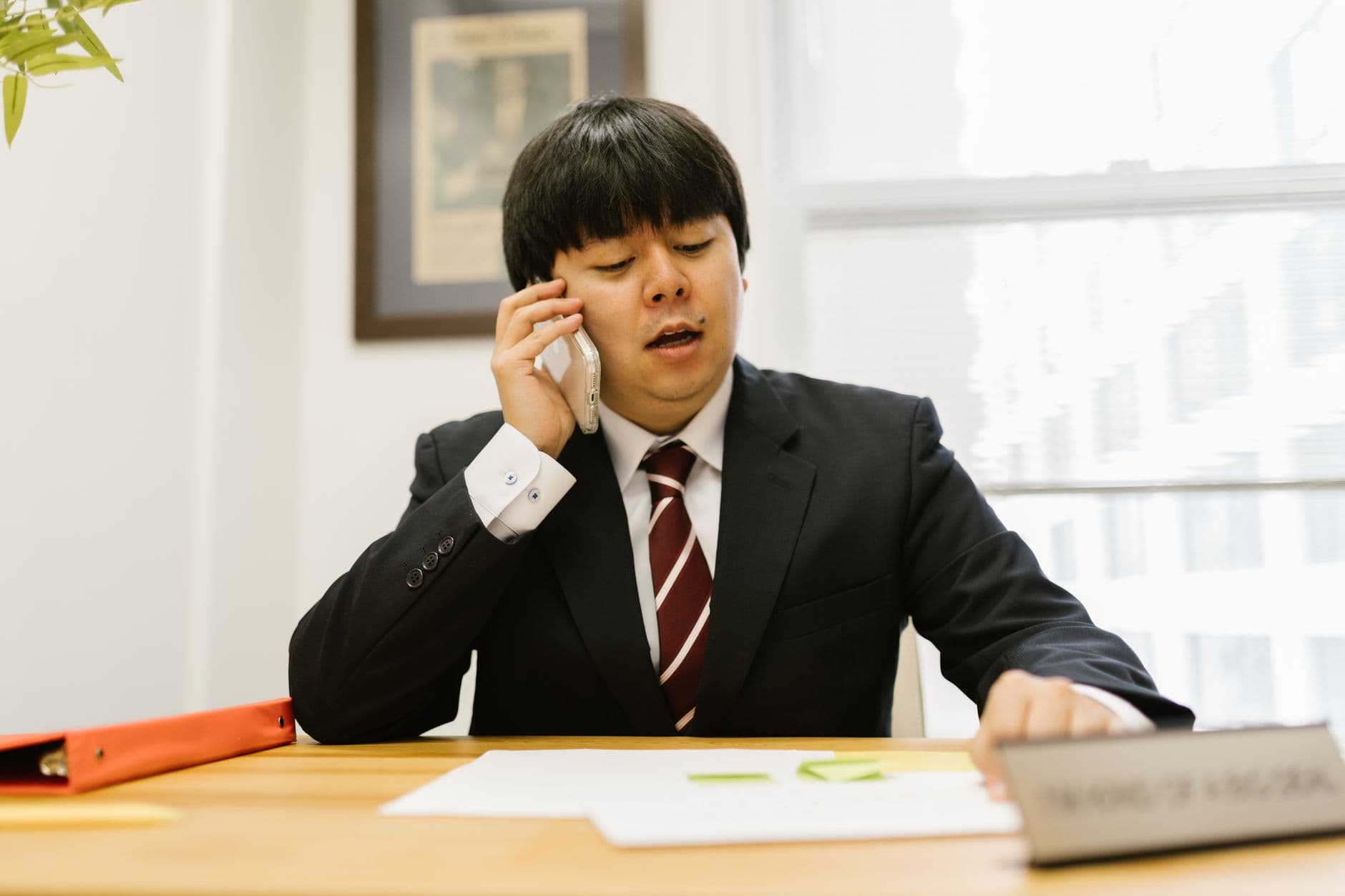 A recruiter making a call at their desk