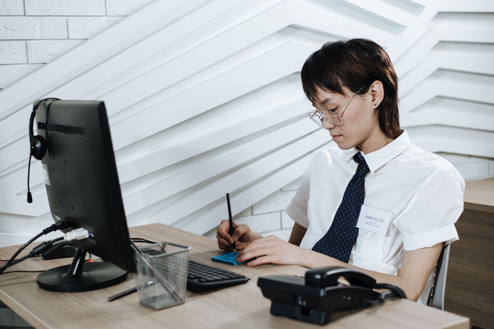 A recruiter on a headset taking a call at their desk