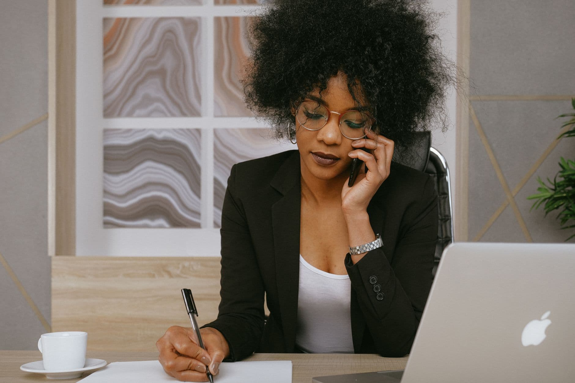 A salesperson making a call at their desk