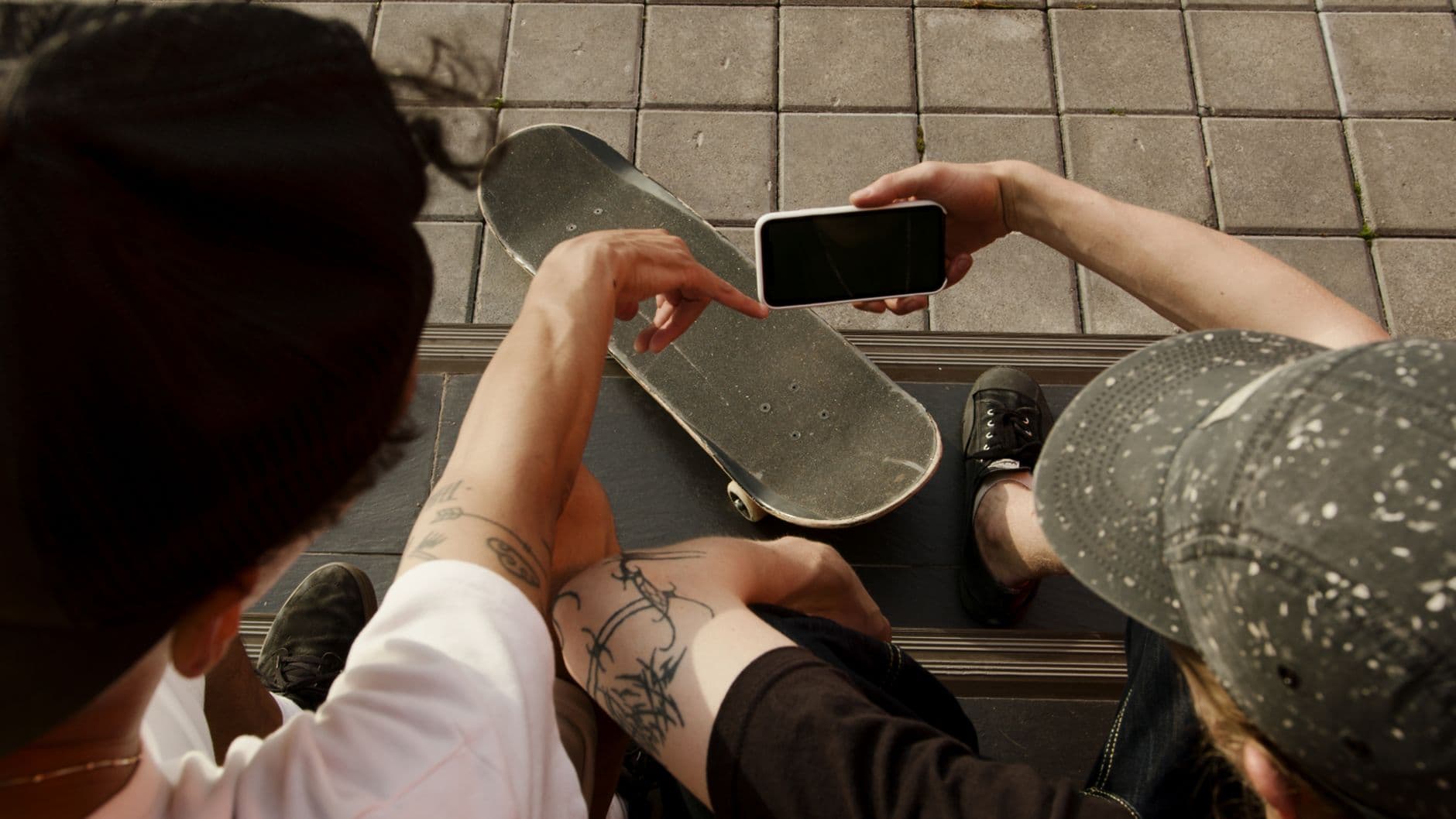 Two people looking at the same phone screen