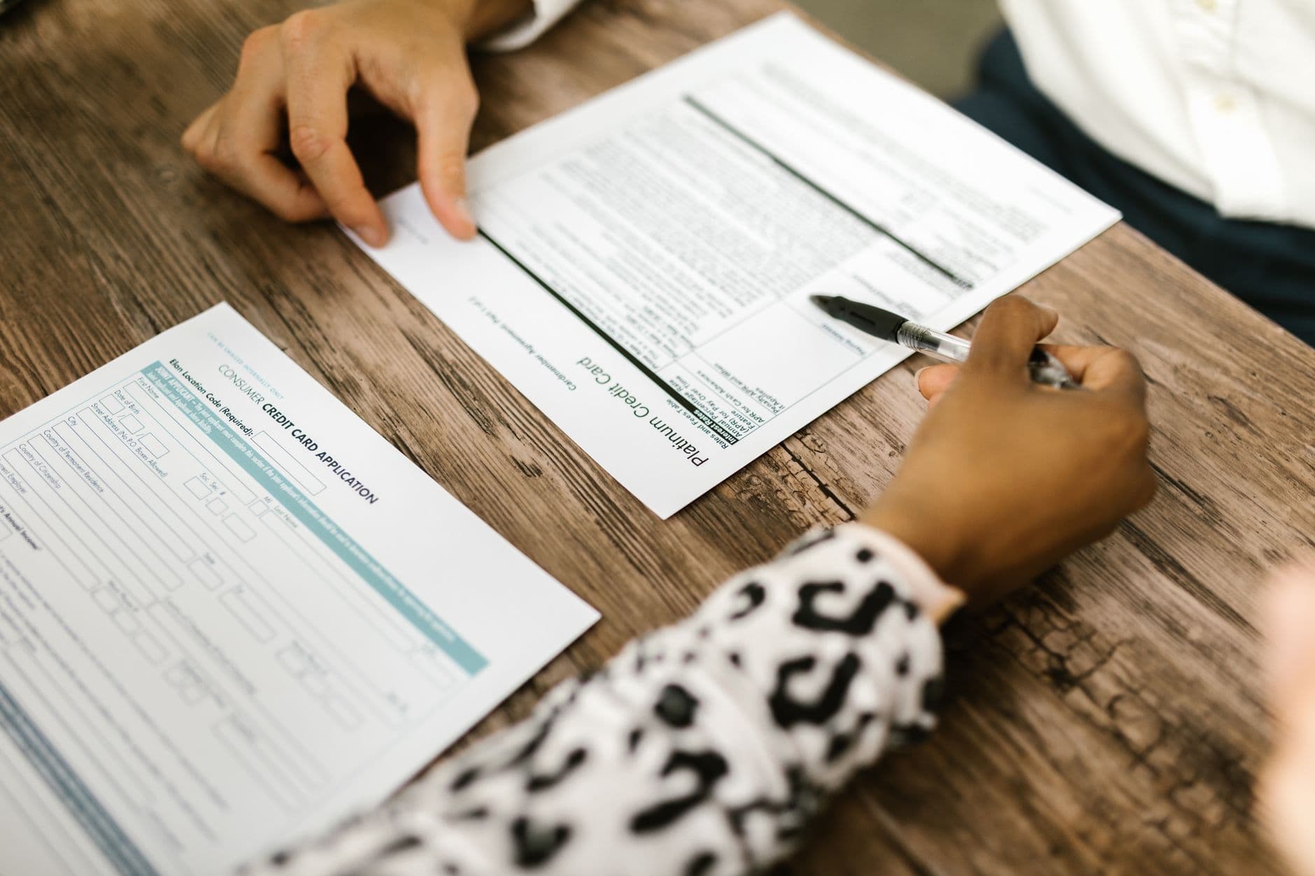 Two people reviewing a printed agreement together